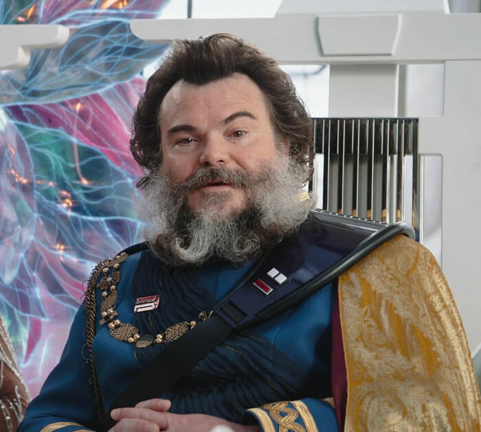 Actor with a full beard wearing a detailed costume, representing unknown things about celebrities shared by people who met them.