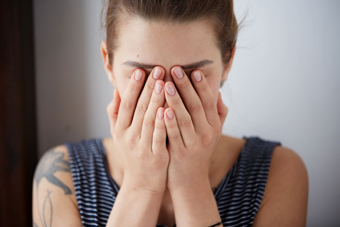Woman covering her face, appearing distressed and rethinking her marriage after disturbing husband’s confession. Woman covering her face, appearing distressed and rethinking her marriage after disturbing husband’s confession.