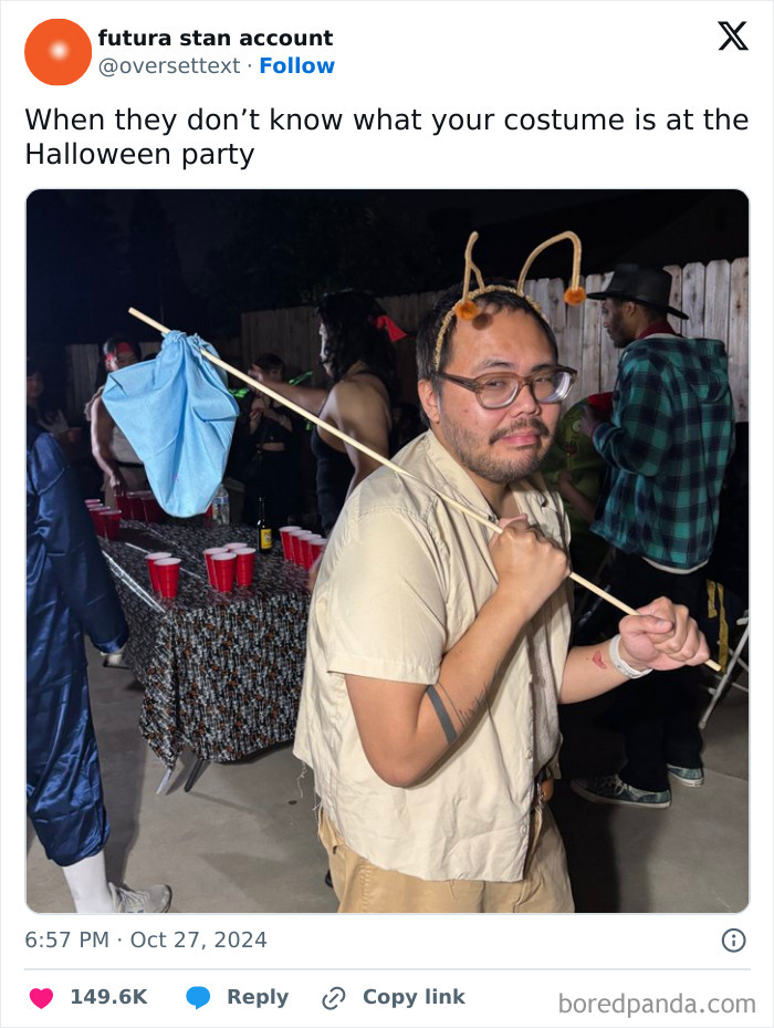 Man wearing a creative Halloween costume with antennae at a party, one of the genius Halloween costumes making people talk.