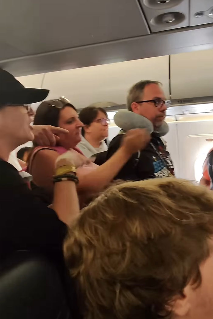 Woman refusing to let passengers exit airplane until her daughter goes first, causing outrage inside cabin. Woman refusing to let passengers exit airplane until her daughter goes first, causing outrage inside cabin.