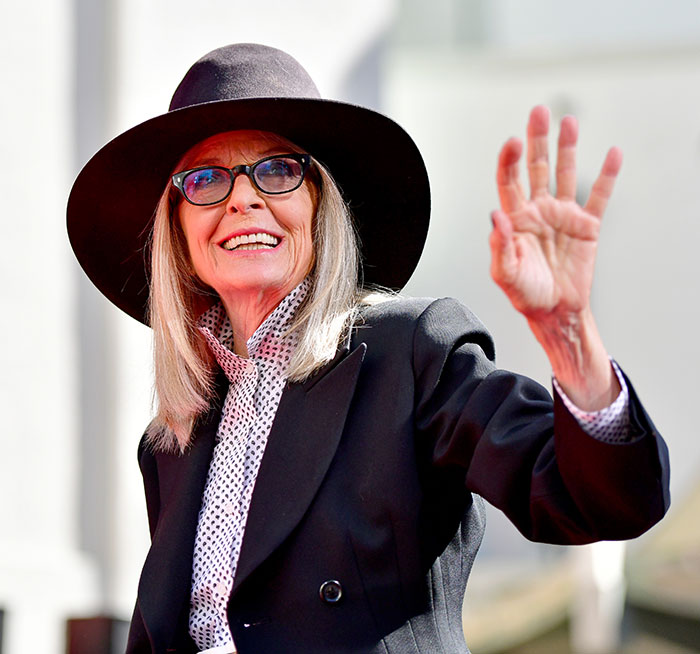 Diane Keaton wearing a black hat and glasses, smiling and waving, capturing a chilling detail to hear about her last moments. Diane Keaton wearing a black hat and glasses, smiling and waving, capturing a chilling detail to hear about her last moments.