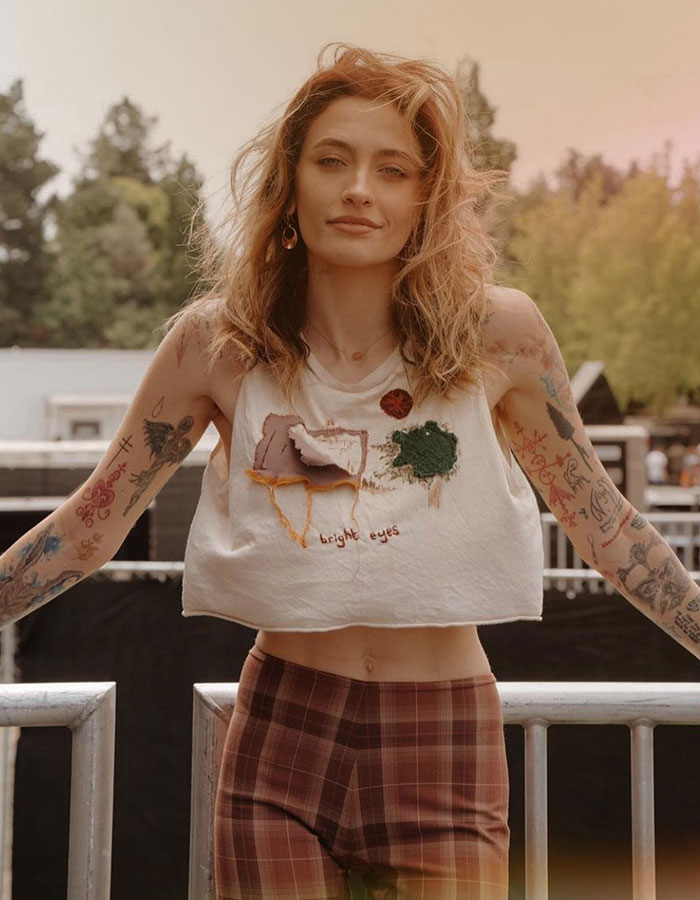 Paris Jackson standing outdoors with tattoos visible, representing Michael Jackson's daughter contacting father's alleged victims. Paris Jackson standing outdoors with tattoos visible, representing Michael Jackson's daughter contacting father's alleged victims.