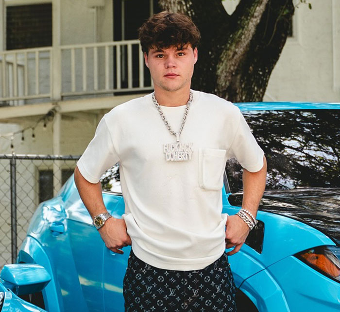 Young man standing confidently by a blue car, highlighting disturbing new details after adult star split from YouTube prankster. Young man standing confidently by a blue car, highlighting disturbing new details after adult star split from YouTube prankster.
