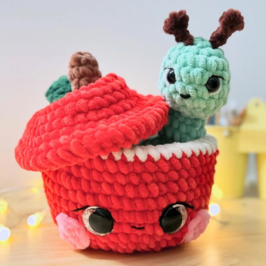 Plush crochet animals with personality, featuring a red acorn and a green creature with antlers in soft yarn.