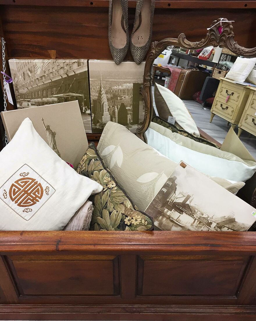 Organized vintage cushions, framed pictures, and shoes neatly stored in a wooden chest illustrating home organization hacks.