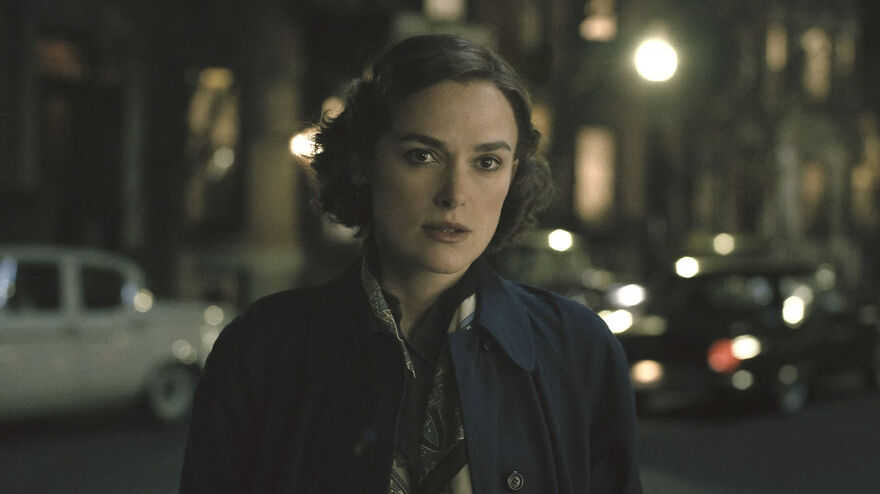 Actress portraying a character in a movie based on true stories that feel impossible to believe, standing outdoors at night.