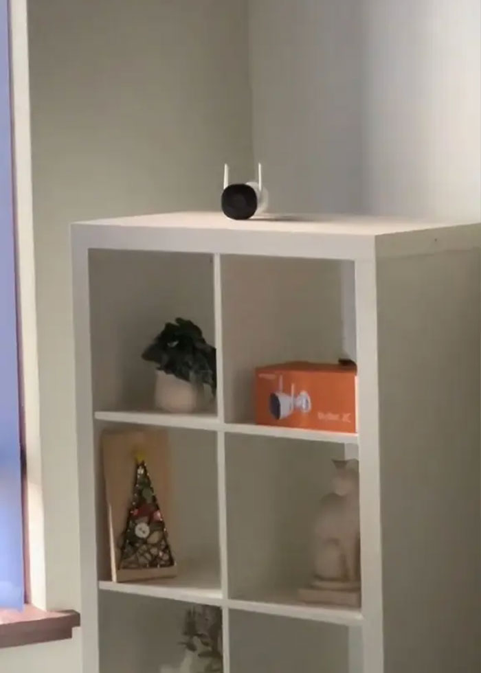 Smart home security camera on shelf inside rental house, hinting at family rush after disturbing discovery indoors. Smart home security camera on shelf inside rental house, hinting at family rush after disturbing discovery indoors.