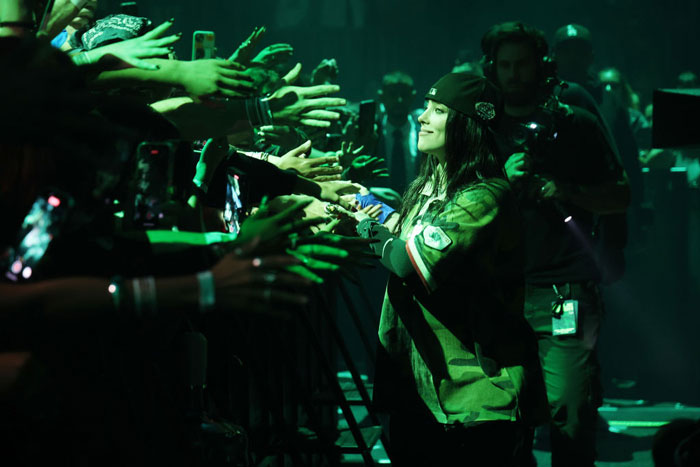 Billie Eilish interacts with fans on stage during Miami concert amid snatching incident outrage. Billie Eilish interacts with fans on stage during Miami concert amid snatching incident outrage.
