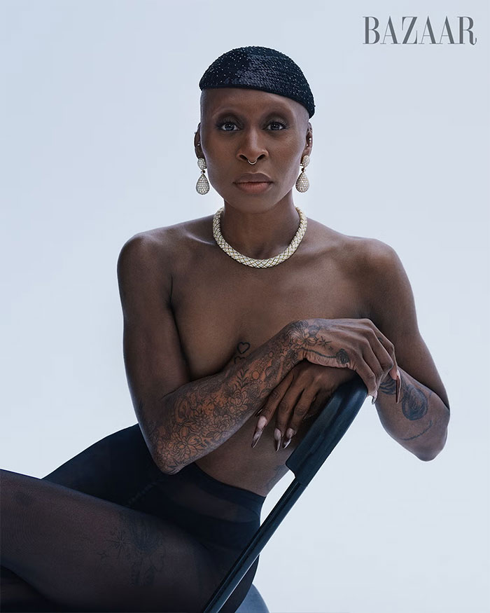 Cynthia Erivo posing topless with tattoos and jewelry in a striking and controversial Harper’s Bazaar fashion shoot. Cynthia Erivo posing topless with tattoos and jewelry in a striking and controversial Harper’s Bazaar fashion shoot.