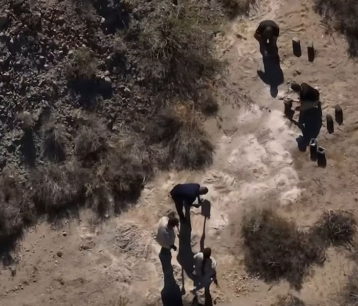 Aerial view of investigators examining piles of human remains in the Las Vegas desert during an urgent probe. Aerial view of investigators examining piles of human remains in the Las Vegas desert during an urgent probe.