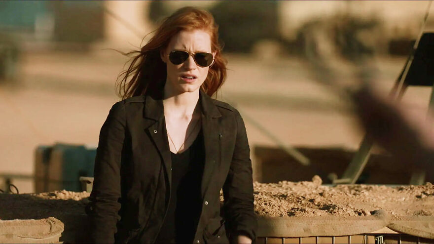 Woman wearing sunglasses and black jacket standing outdoors in a scene from movies based on true stories that feel impossible to believe