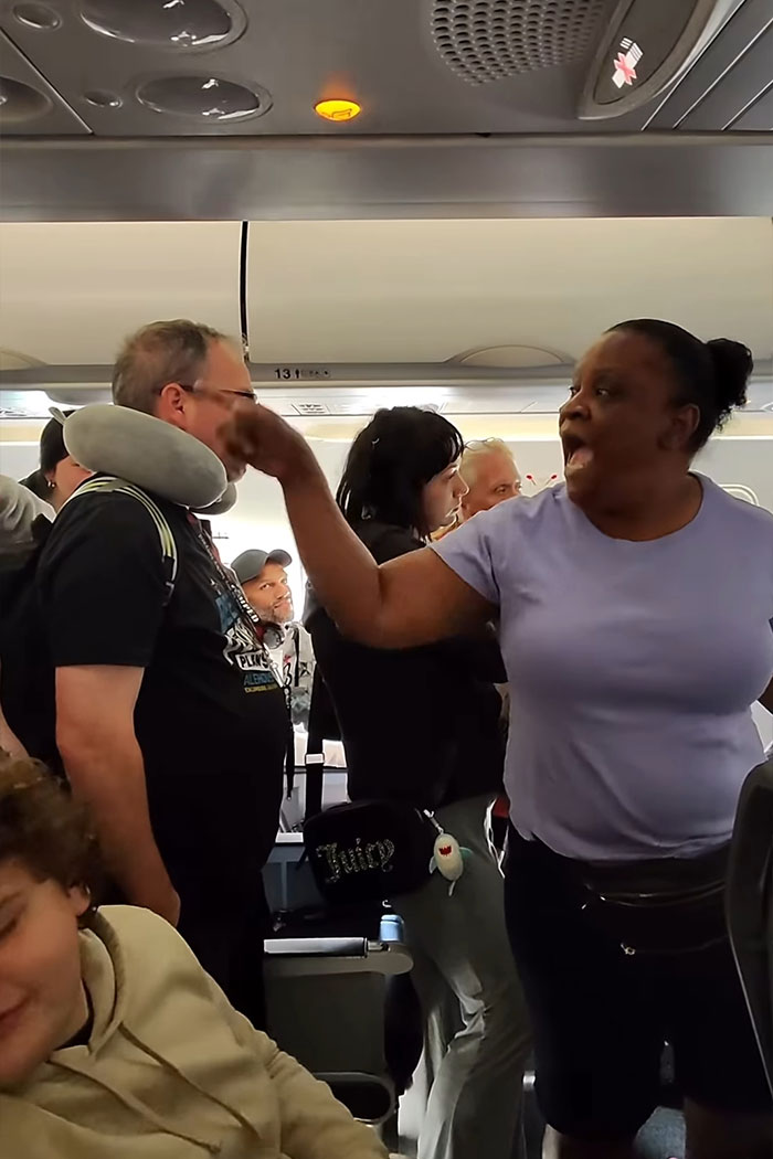 Woman refusing to let passengers exit airplane until her daughter goes first, causing outrage and disruption in cabin. Woman refusing to let passengers exit airplane until her daughter goes first, causing outrage and disruption in cabin.