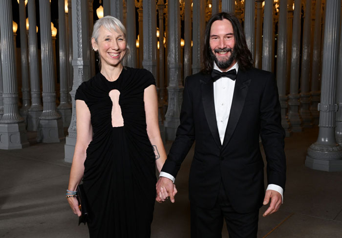 Keanu Reeves and Alexandra Grant holding hands at a formal event amid marriage rumors speculation. Keanu Reeves and Alexandra Grant holding hands at a formal event amid marriage rumors speculation.