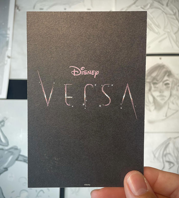 Hand holding black card with Disney Versa logo, related to new Disney film sparking heterosexual breeding propaganda backlash online. Hand holding black card with Disney Versa logo, related to new Disney film sparking heterosexual breeding propaganda backlash online.