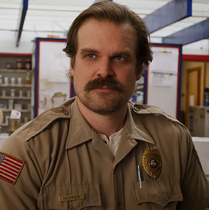 David Harbour in police uniform as Hopper, fans clash online over whether he deserves to be fired for cheating claims. David Harbour in police uniform as Hopper, fans clash online over whether he deserves to be fired for cheating claims.