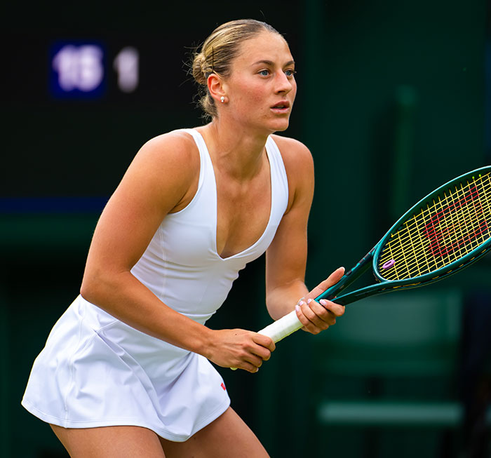 Female tennis player in white outfit focused during match amid testosterone remark controversy and rival’s bikini photo response. Female tennis player in white outfit focused during match amid testosterone remark controversy and rival’s bikini photo response.