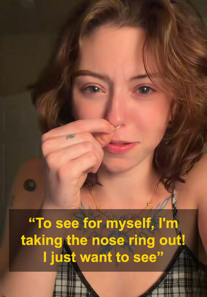 Young woman removing nose ring in close-up, going viral after men say she looks like a Democrat without it. Young woman removing nose ring in close-up, going viral after men say she looks like a Democrat without it.