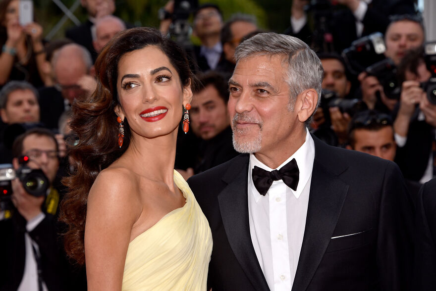 George And Amal Clooneyat a red carpet event, showcasing enduring celebrity charm and style.