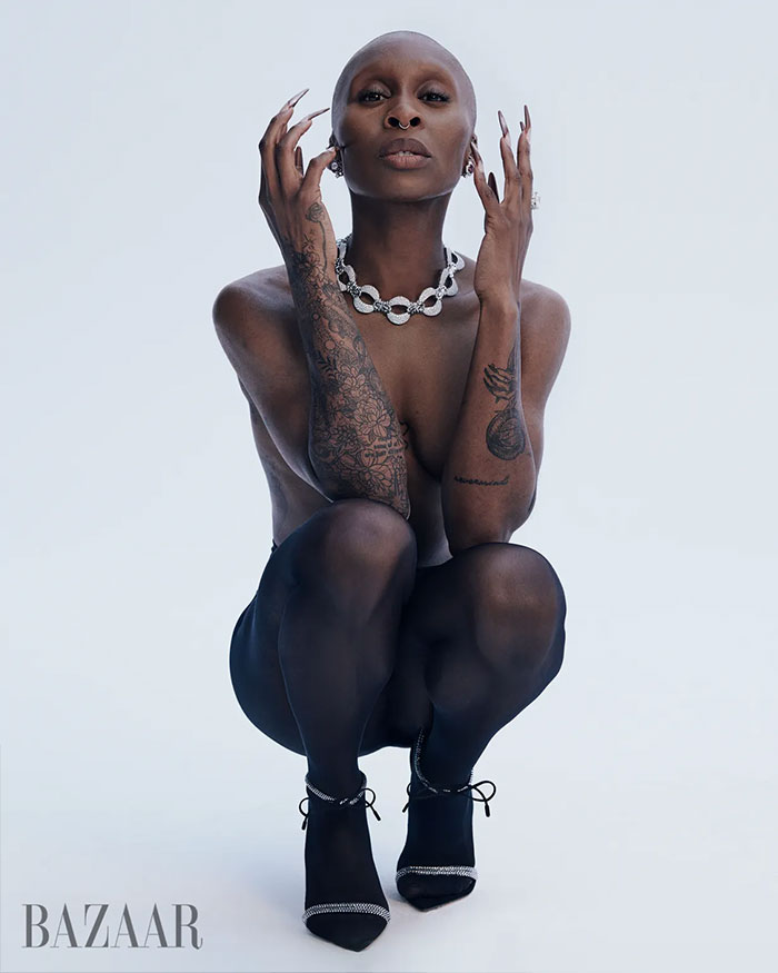 Cynthia Erivo posing in sheer black tights and heels with tattoos and jewelry in controversial Harper’s Bazaar shoot. Cynthia Erivo posing in sheer black tights and heels with tattoos and jewelry in controversial Harper’s Bazaar shoot.