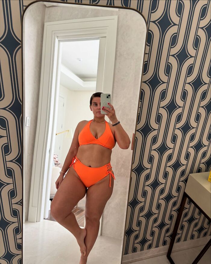 Nelly Furtado taking a mirror selfie in an orange bikini, highlighting body positivity amid online body-shaming issues. Nelly Furtado taking a mirror selfie in an orange bikini, highlighting body positivity amid online body-shaming issues.