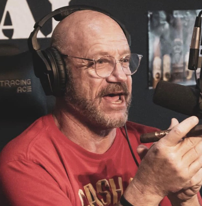 Man with glasses and headphones speaking into a microphone, discussing America’s most notorious jewel thief and smuggling tricks. Man with glasses and headphones speaking into a microphone, discussing America’s most notorious jewel thief and smuggling tricks.
