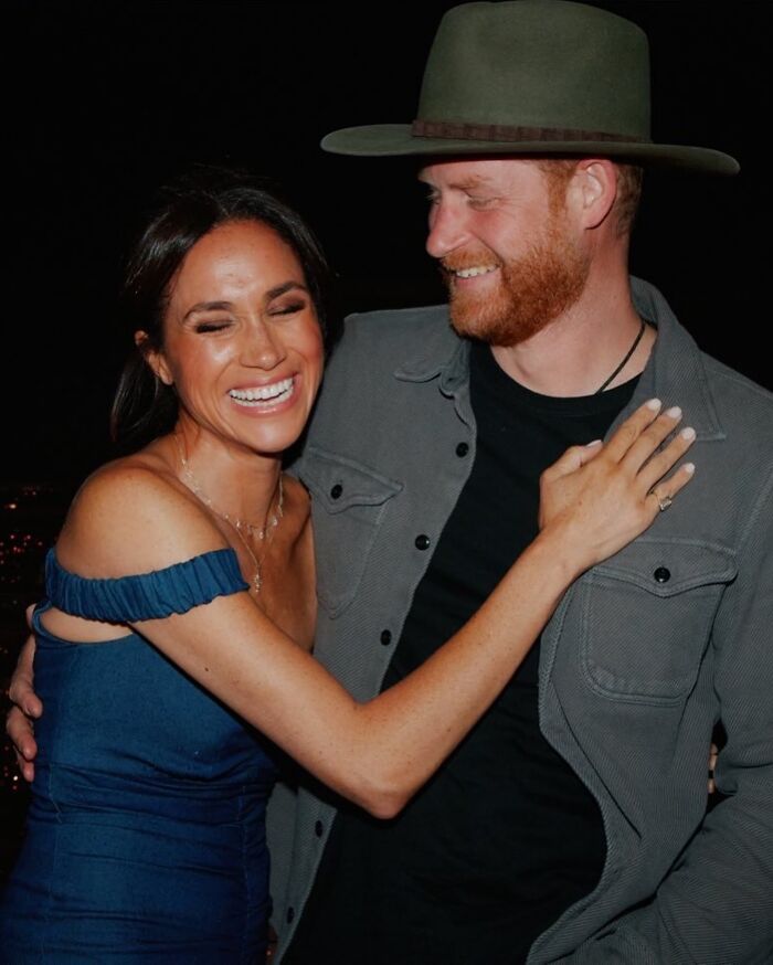 Meghan Markle smiling and embracing a man, highlighted during her Paris Fashion Week appearance sparking reactions. Meghan Markle smiling and embracing a man, highlighted during her Paris Fashion Week appearance sparking reactions.