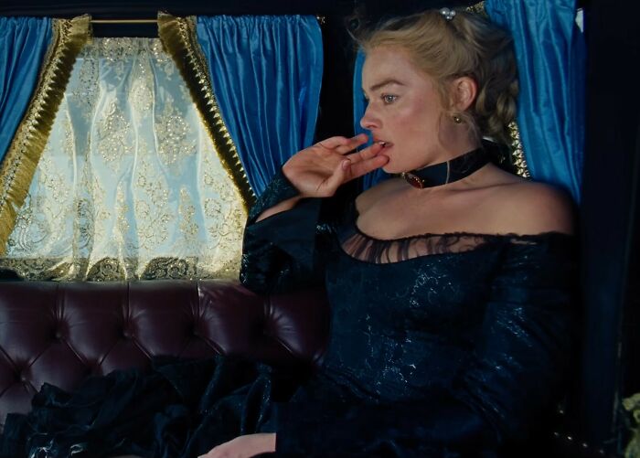 Margot Robbie in a provocative Wuthering Heights trailer scene, dressed in dark period costume inside a carriage. Margot Robbie in a provocative Wuthering Heights trailer scene, dressed in dark period costume inside a carriage.