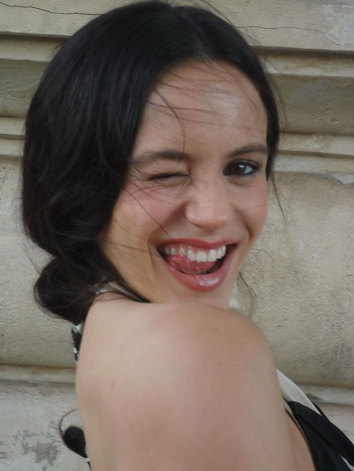 Pop star at Paris Fashion Week winking and smiling, highlighting her dyed armpit hair sparking mixed reactions. Pop star at Paris Fashion Week winking and smiling, highlighting her dyed armpit hair sparking mixed reactions.