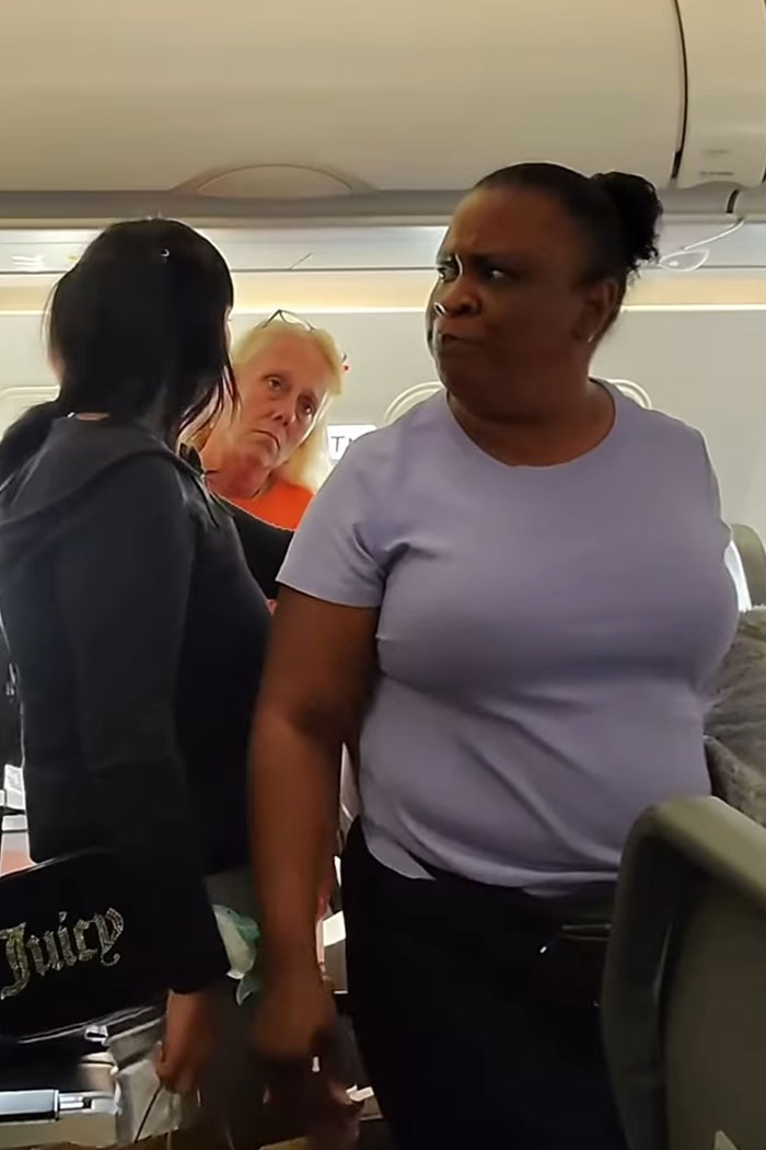 Woman refusing to let passengers exit an airplane until her daughter goes first causing outrage among travelers. Woman refusing to let passengers exit an airplane until her daughter goes first causing outrage among travelers.