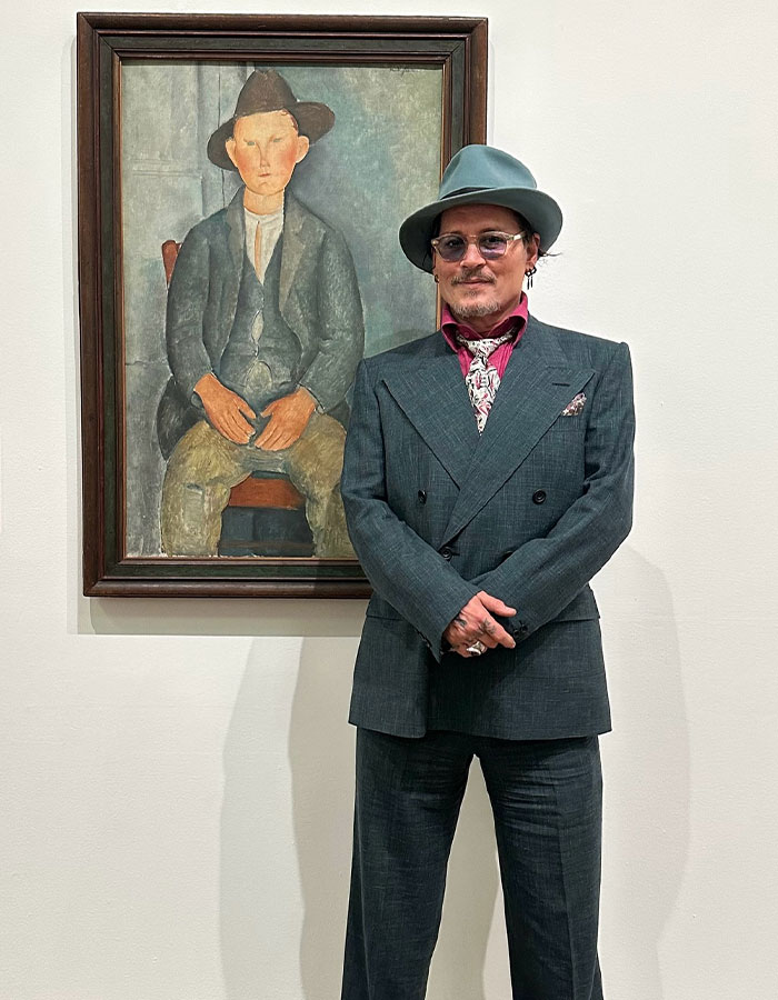 Johnny Depp in a suit and hat standing next to a framed painting, related to Johnny Deppâs new movie role backlash. Johnny Depp in a suit and hat standing next to a framed painting, related to Johnny Deppâs new movie role backlash.