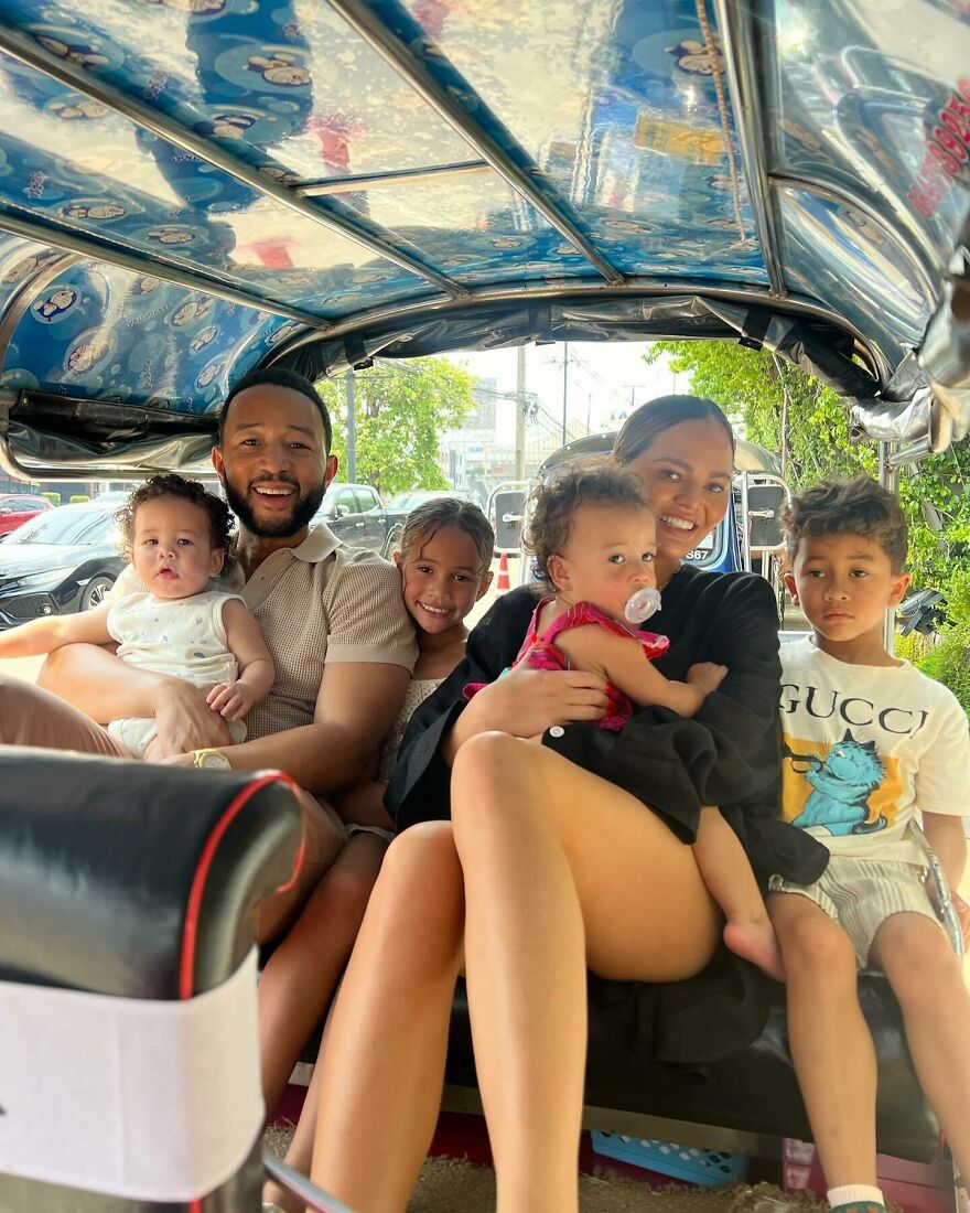 Chrissy Teigen And John Legend with their children enjoying a sunny day outdoors in a casual family moment.