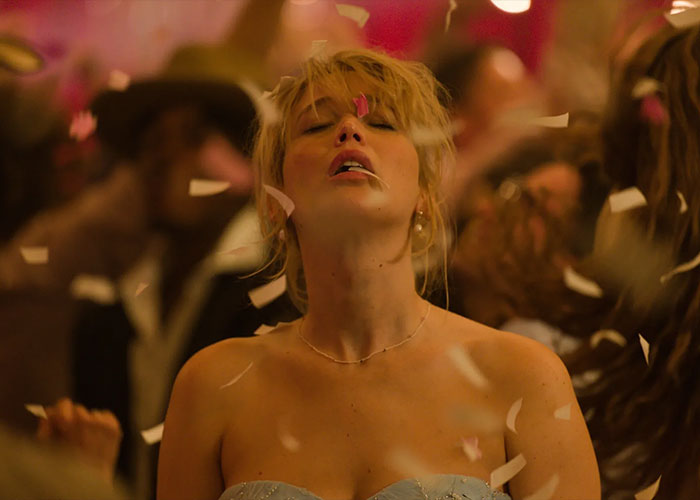 Jennifer Lawrence at a party with confetti falling, addressing plastic surgery plans after viral video reaction. Jennifer Lawrence at a party with confetti falling, addressing plastic surgery plans after viral video reaction.