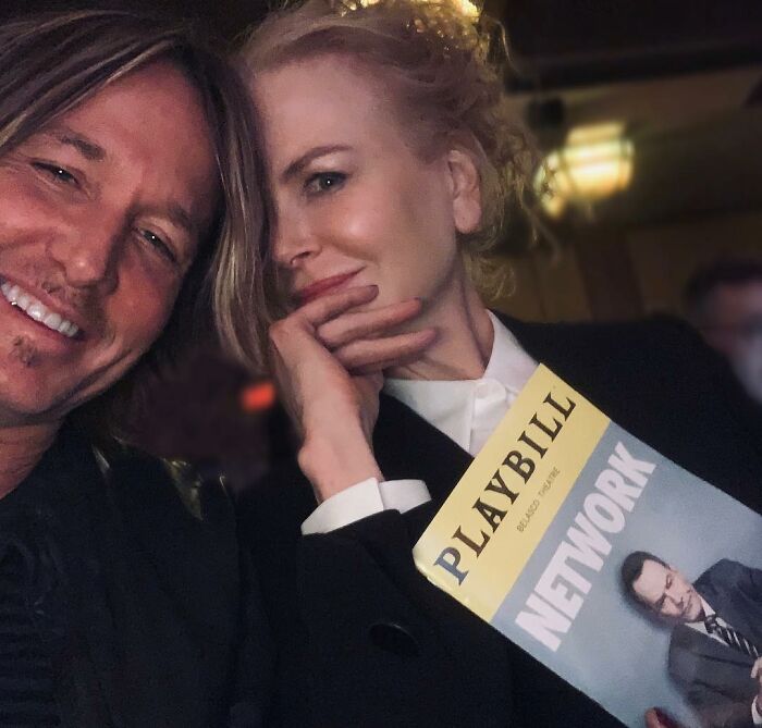 Nicole Kidman and Keith Urban smiling together, Nicole holding a Playbill for Network in a dimly lit setting. Nicole Kidman and Keith Urban smiling together, Nicole holding a Playbill for Network in a dimly lit setting.