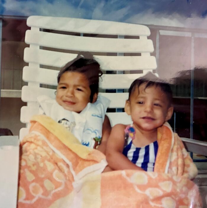 Two young sisters wrapped in towels sitting on a lounge chair, representing the miracle of their discovery after 36 years. Two young sisters wrapped in towels sitting on a lounge chair, representing the miracle of their discovery after 36 years.