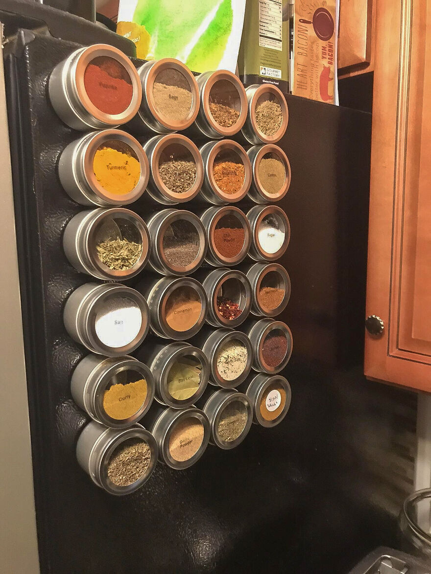 Magnetic spice jars organized neatly on a refrigerator door, showcasing effective home organization hacks.