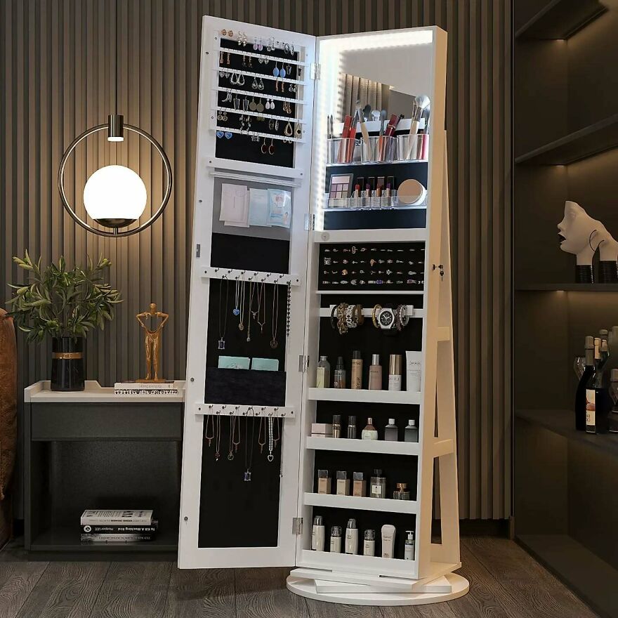 Tall white storage cabinet with LED mirror light organizing jewelry and cosmetics, showcasing top organization hacks for home.