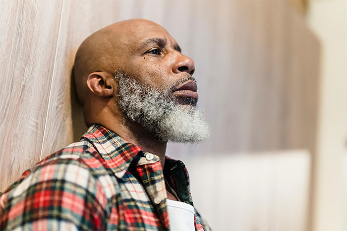 Middle-aged man with gray beard and plaid shirt looking pensive, symbolizing brutal truth after leaving wife for younger woman. Middle-aged man with gray beard and plaid shirt looking pensive, symbolizing brutal truth after leaving wife for younger woman.