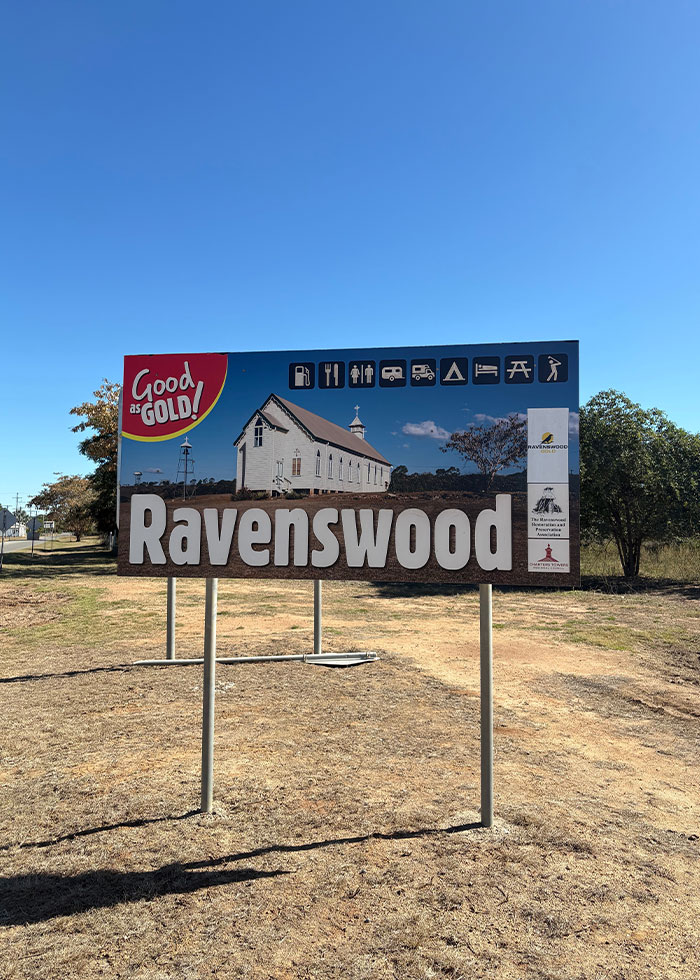 Roadside sign for Ravenswood town with a historic church under clear blue sky, related to woman knocked unconscious by bird insurance story. Roadside sign for Ravenswood town with a historic church under clear blue sky, related to woman knocked unconscious by bird insurance story.