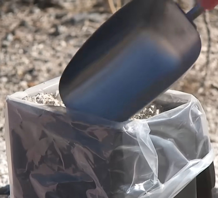 Black shovel scooping soil into a plastic-lined container during urgent investigation in Las Vegas desert remains discovery Black shovel scooping soil into a plastic-lined container during urgent investigation in Las Vegas desert remains discovery