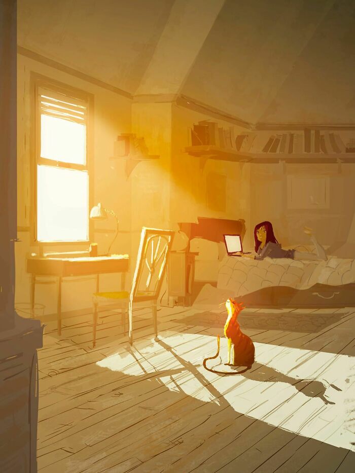 A softly lit room where an artist transforms the everyday with warm light, a cat, and a person working on a laptop.