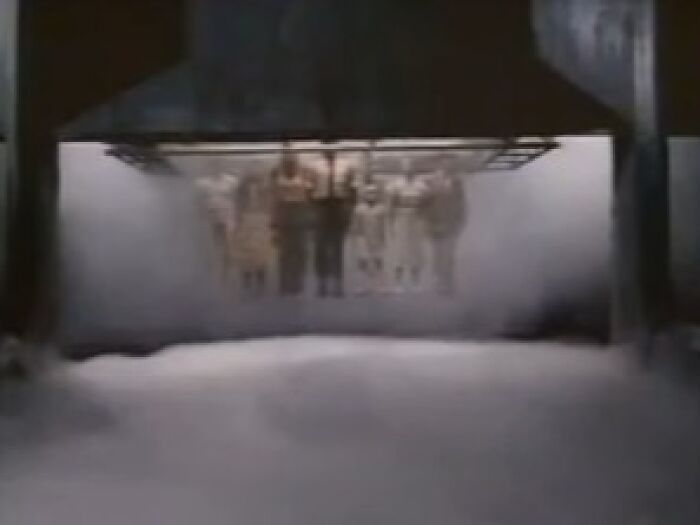 Blurry scene of hanging figures surrounded by fog in a dark setting from creepy commercials with eerie atmosphere.