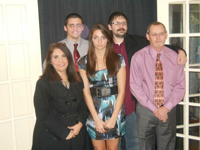 Family group photo with awkward expressions, a common theme in cringed or laughed at family photos online.