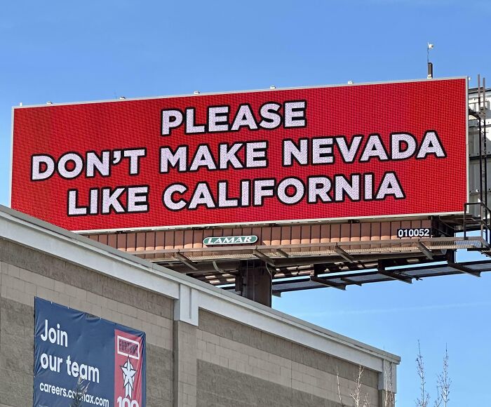 Funny and weird billboard in Nevada with a bold red background saying please don’t make Nevada like California