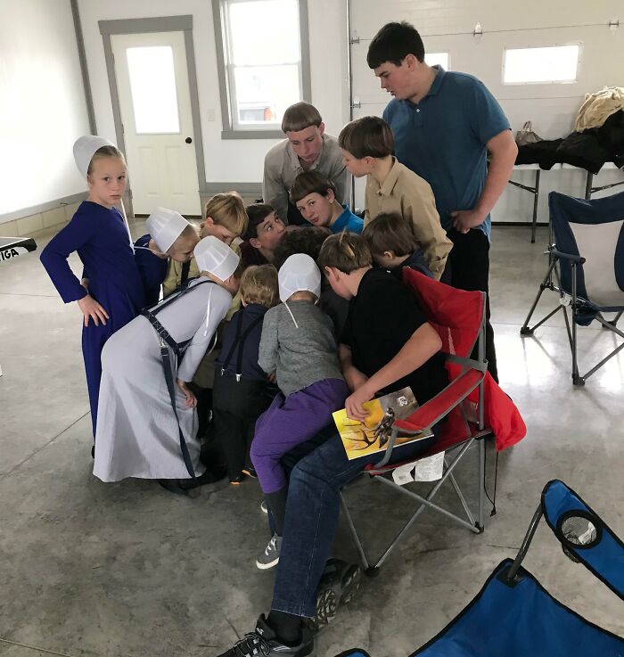 Large group of family members laughing together in a candid photo moment, capturing funny family photo memories.