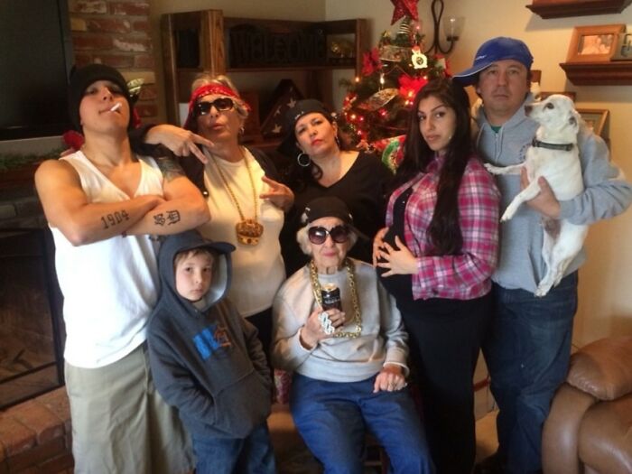 Family photo with multiple generations posing in exaggerated hip-hop style, capturing a cringed and funny moment online.