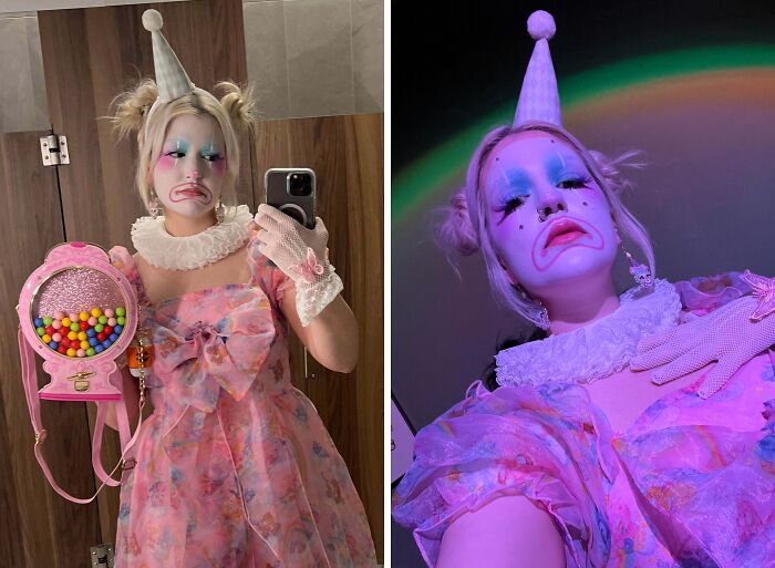 Person in a pink clown costume with dramatic makeup and a hat, holding a gumball purse, showcasing Halloween costumes.