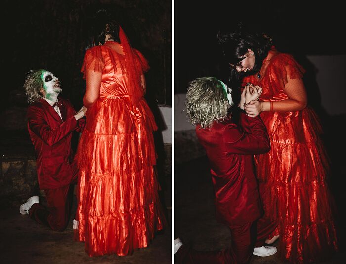 Couple in genius Halloween costumes with a man dressed as the Joker in a red suit and a woman in a red vintage dress.