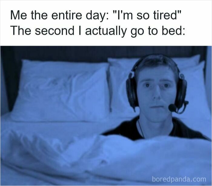 Person wearing a headset sitting wide awake in bed, illustrating insomnia and funny insomnia memes about sleepless nights.