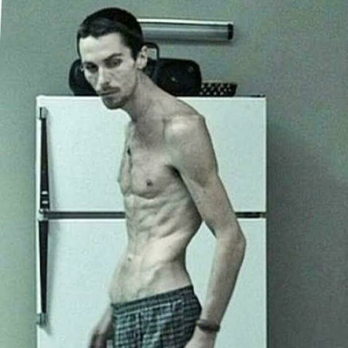 Extremely thin man standing in front of a refrigerator, illustrating a fascinating photo that may help you see the world differently.