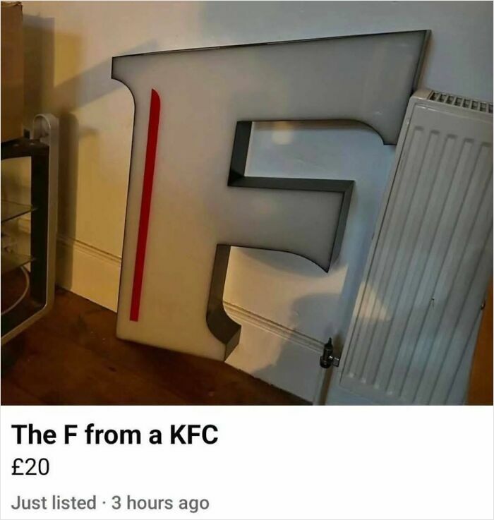 Out of context occult humor featuring a large F from a KFC sign leaning against a wall near a radiator.